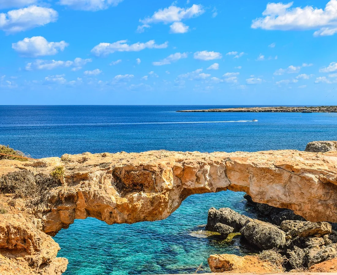 Illustrative Mediterranean limestone coast with turquoise sea and warm sunshine